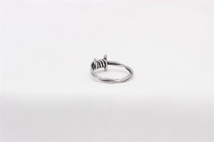 Macro shot of silver retro punk ring featuring industrial barbed wire metal design