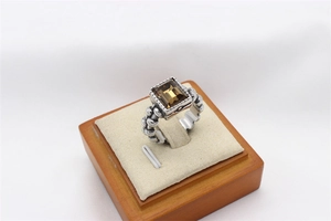 Macro detail of vintage silver ring with rectangular smoky quartz and woven texture
