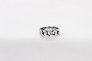 Macro shot of retro stainless steel cuban link chain ring with oxidized finish