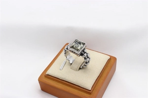 Detail of vintage industrial ring with square gemstone and beaded textured silver band