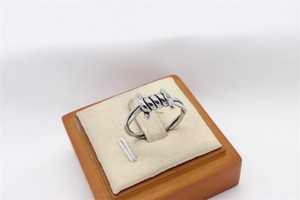 Detailed industrial silver screw design ring on a jewelry display stand