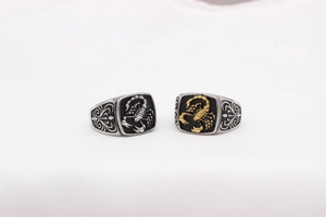 Detailed macro view of vintage stainless steel punk rings with scorpion relief patterns