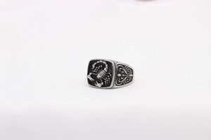 Detailed close-up of retro silver stainless steel ring featuring relief scorpion pattern