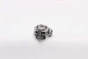 Macro detail of retro skull ring with oxidized finish and spiral patterns