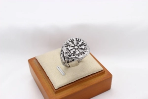 Macro detail of silver Viking Vegvisir compass ring with vintage oxidized finish