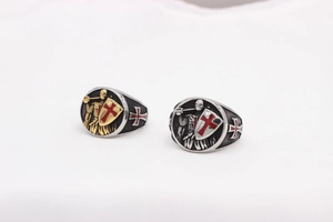 Detail of vintage knight shield rings with red cross patterns in gold and silver finish
