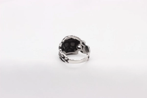 Macro shot of retro silver skull ring showing detailed relief pattern and 925 stamp