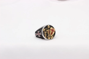 Macro detail of crusader knight relief with red cross shield on stainless steel ring
