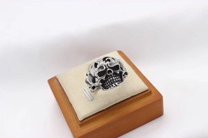 Detail of vintage silver skull ring with gothic blackened finish on a suede display stand