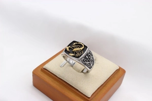 Macro detail of men's vintage scorpion ring with gold insect and engraved floral patterns