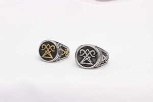 Close-up of vintage Viking steel rings featuring engraved mystical occult symbols