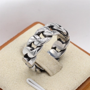 Retro Cuban link chain ring for men in vintage stainless steel on a beige stand