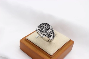 Macro view of vintage stainless steel Viking ring featuring the Sigil of Lucifer engraving