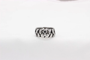 Close-up of vintage chain texture on silver stainless steel ring with polished finish