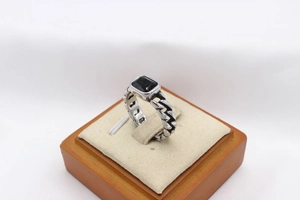 Macro shot of vintage chain-style titanium steel ring with a square black gemstone