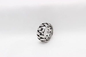Macro detail of men's titanium steel ring with vintage chain weave and hollow design