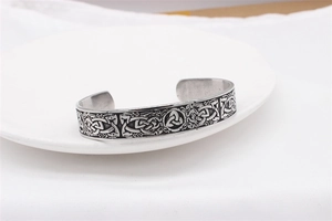 Detail of Viking Celtic Knot open cuff bracelet in vintage finish on a white plate