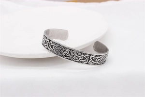 Detail of vintage Celtic triquetra engraving on a retro stainless steel men's cuff bracelet