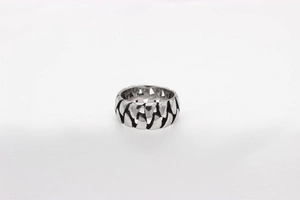 Close-up of retro chain pattern and hollow industrial design on silver titanium steel ring