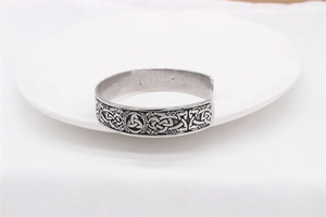 Macro shot of Viking stainless steel bangle with engraved Celtic knot and Triquetra patterns