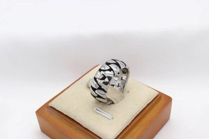 Macro detail of men's vintage chain-link steel ring with oxidized finish