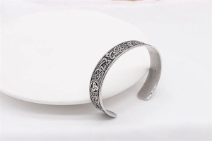 Detail of vintage silver Viking steel bangle with intricate Nordic Celtic knot carvings