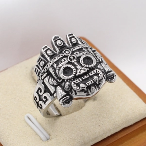 Vintage silver-tone alien mask ring in retro punk style for men on velvet tray