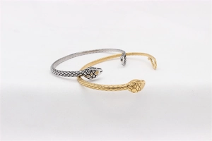Detailed view of snake-head bangles featuring realistic scales in gold and silver finish