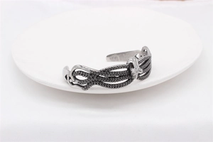 Detailed view of octopus tentacles and suckers on silver stainless steel cuff bracelet