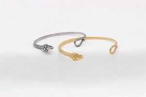 Detail of vintage snake bangle set in gold and silver with realistic scale textures