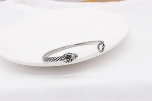 Detailed view of vintage snake bracelet with intricate scale texture and gothic design