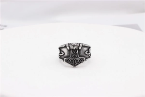 Detailed macro view of Viking Mjölnir ring with intricate Celtic knot engraving