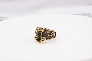 Detailed relief of Viking Mjolnir hammer and Triquetra knot on vintage steel ring