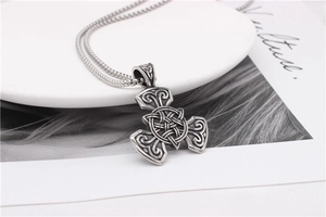Macro shot of Viking Celtic knot pendant in vintage black finish on a steel chain