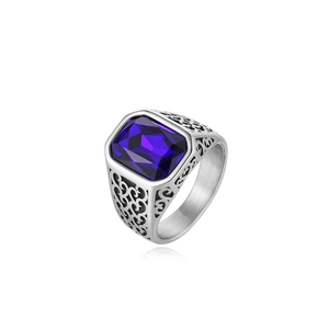 Close-up of rectangular purple gemstone and ornate hollow carvings on steel ring