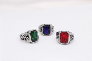 Macro detail of three vintage steel rings with emerald, sapphire, and ruby gemstones