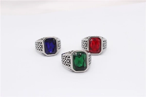 Detailed view of three vintage titanium steel rings with emerald-cut gems and filigree