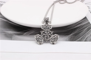 Close-up of vintage Celtic knot pendant with oxidised finish on a box chain necklace