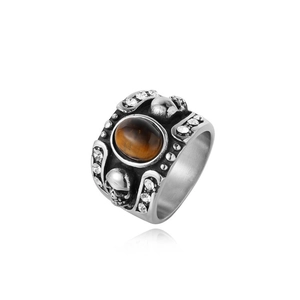 Detailed view of vintage steel ring with tiger eye stone and skull relief carvings