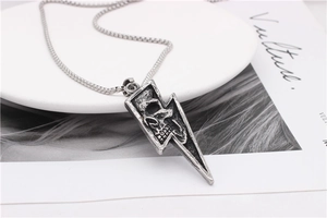 Close-up of retro punk skull lightning pendant necklace with vintage oxidized finish