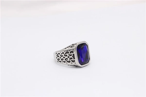 Detail view of rectangular blue gemstone set in a vintage hollow pattern ring band