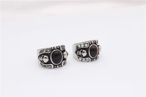 Detailed relief of gothic skull rings with black onyx and tiger eye gemstones