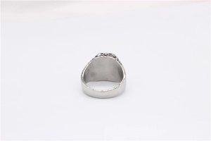 Close-up of vintage rectangle signet ring with hollow engraved floral side details