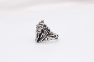 Macro view of vintage Ganesha relief on titanium steel ring with oxidized finish