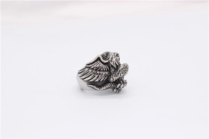 Detailed close-up of retro eagle ring showing intricate feather textures and vintage finish