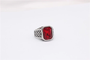 Macro shot of rectangular red gemstone ring with vintage floral filigree engraving