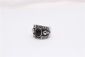 Detailed close-up of gothic skull ring featuring a large oval black gemstone inlay