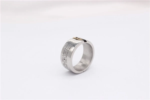 Close-up of industrial steel ring with engraved philosophical text and bi-color inlay