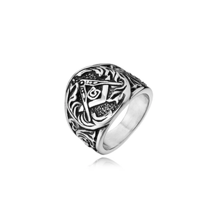 Macro detail of retro steel Masonic ring featuring Freemasonry logo and embossed patterns