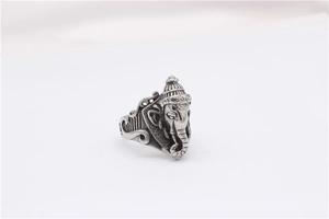 Macro detail of vintage Ganesha relief on silver-tone stainless steel ring